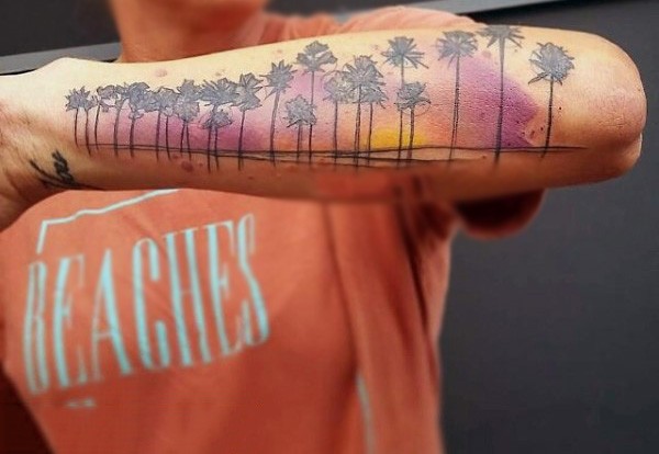 Cool colored beach with palm trees tattoo on arm