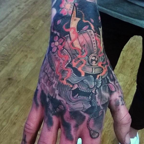 Cool comic books style cartoon demonic samurai helmet tattoo on hand