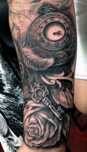Cool designed black and white  old antic clock with feather and key tattoo on leg