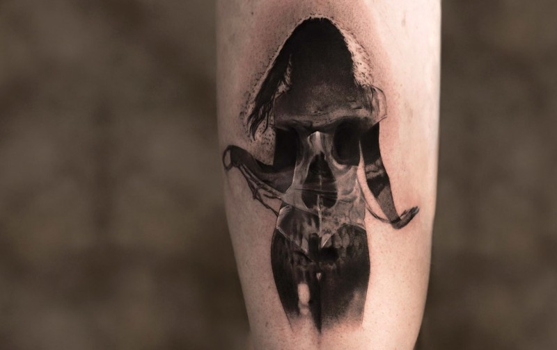 Cool designed black ink tattoo of human silhouette and skull