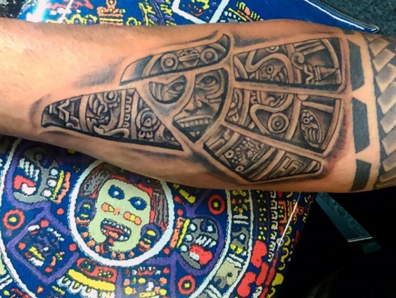 Cool eagle shaped black ink forearm tattoo stylized with tribal ornaments