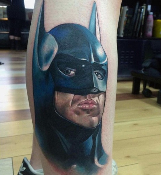 Cool illustrative style colored leg tattoo of Batman face