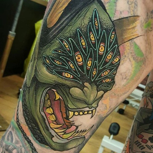 Cool illustrative style leg tattoo of evil monster face