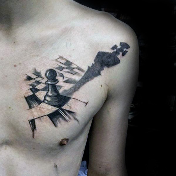 Cool looking black ink chest tattoo of small chess figure