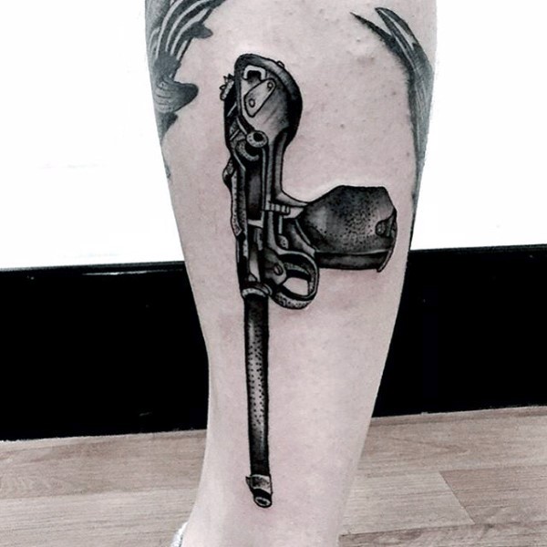 Cool looking black ink engraving style leg tattoo of old pistol