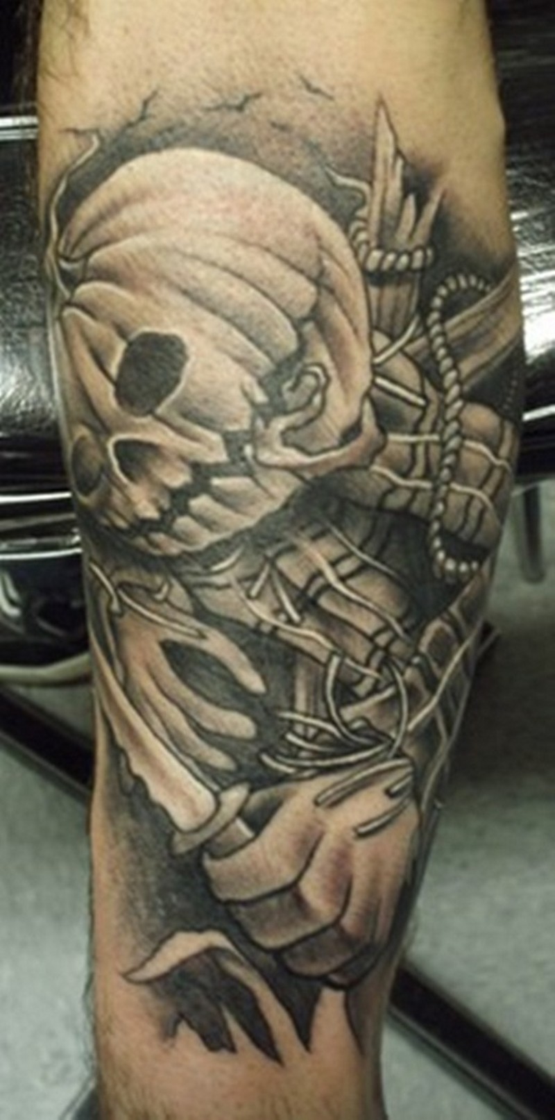 Cool looking colored forearm tattoo of cartoon like pumpkin monster with knife
