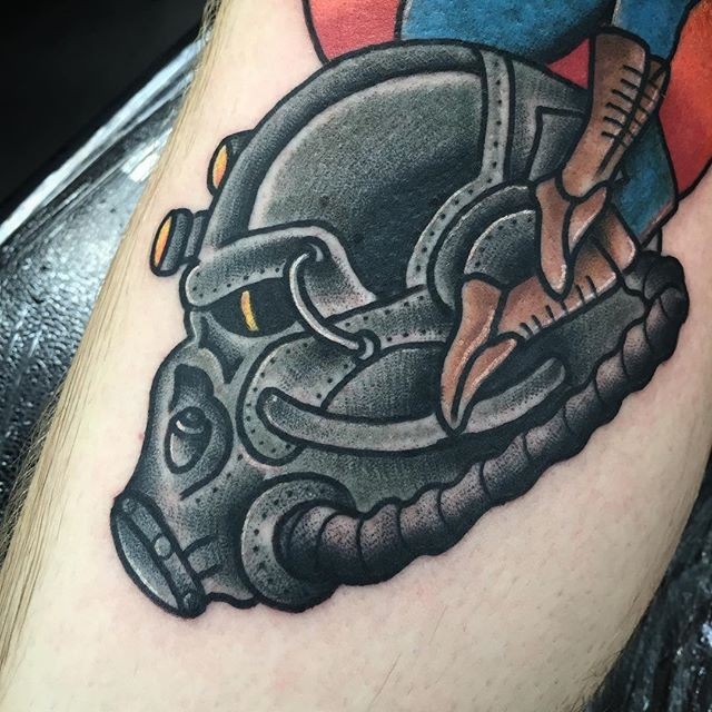 Cool looking colored leg tattoo of Fallout armor helmet