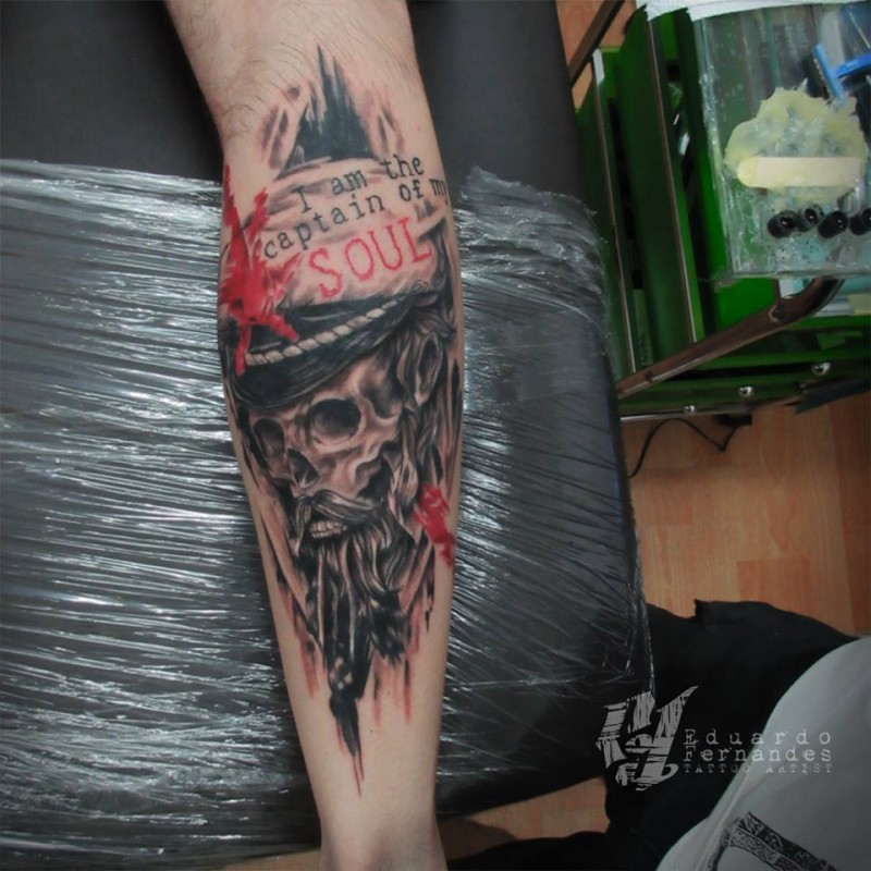 Cool looking colored old pirates skull tattoo on leg with lettering