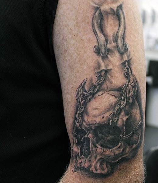 Cool mysterious looking black and white chained skull tattoo on shoulder