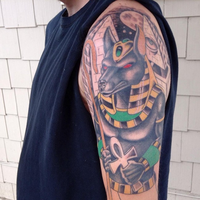 Cool painted half colored shoulder tattoo of Egypt God Seth with pyramids