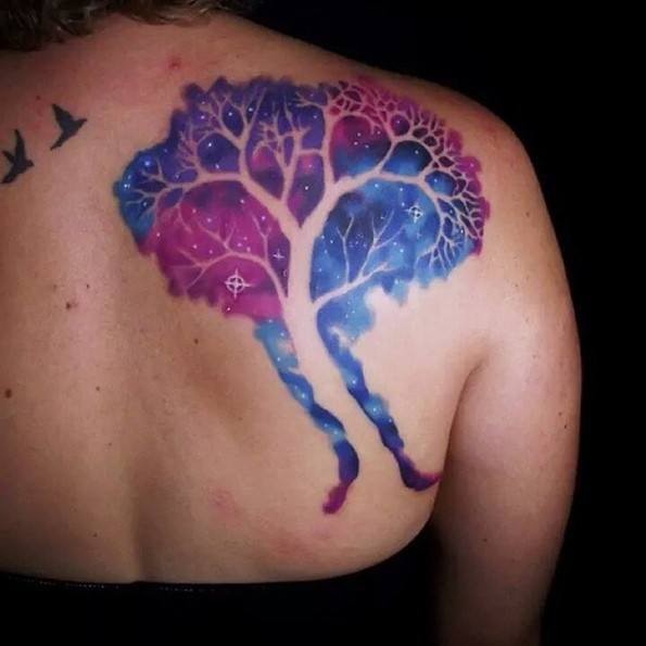 Cool space themed big colored back tattoo of lonely tree