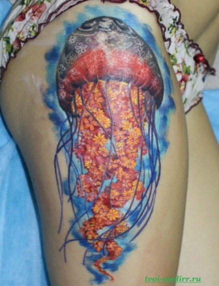 Cool very realistic colored big jelly-fish stylized with flowers tattoo on thigh