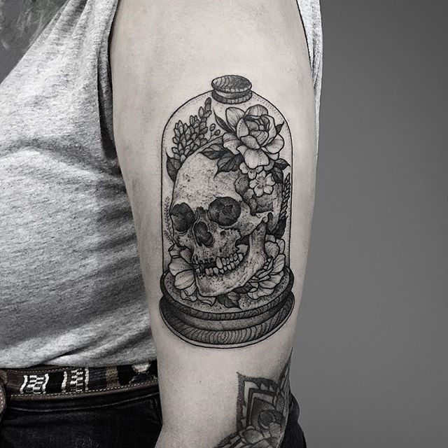 Creative designed dotwork style upper arm tattoo of human skull in bulb