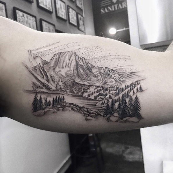 Creative dot style biceps tattoo of countryside with mountains ...