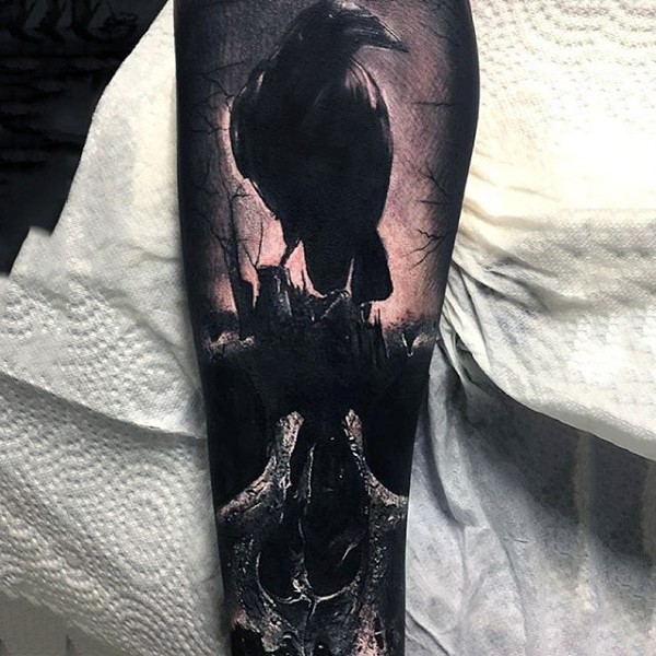 Creepy  black ink realistic crow with skull tattoo on arm