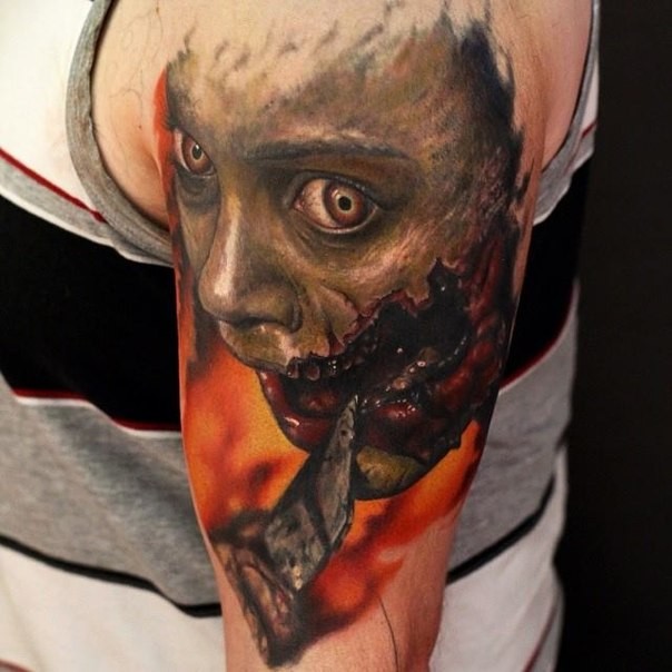 Creepy colored horror movie like bloody monster tattoo on shoulder