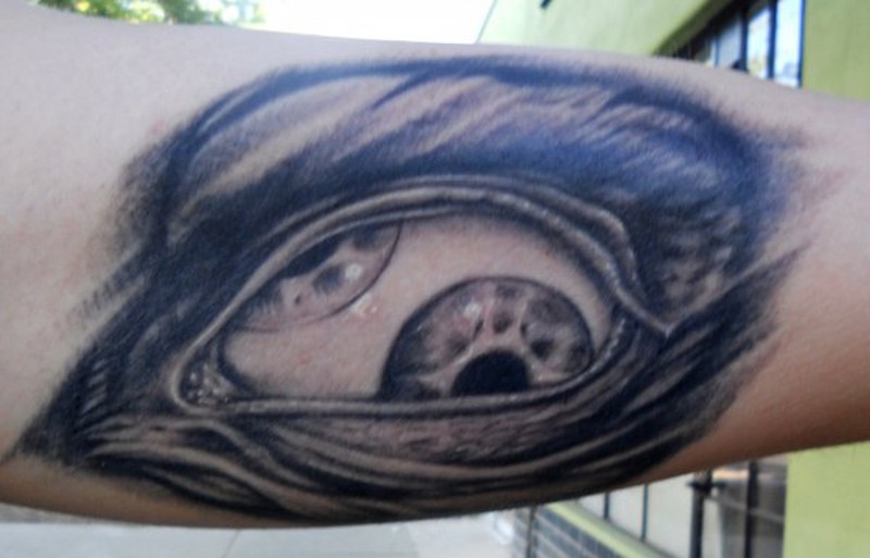 Creepy designed big black and white eye tattoo on arm