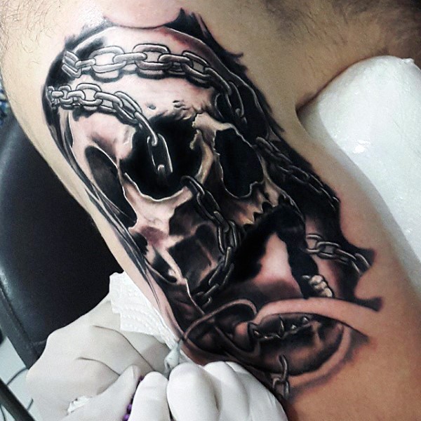 Creepy designed black and white chained old skull tattoo on arm