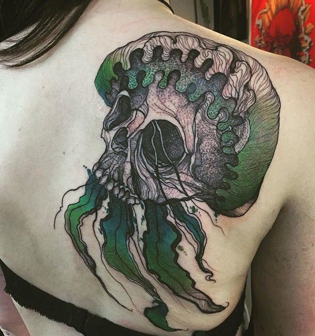 Creepy dot style scapular tattoo of human skull with leaves