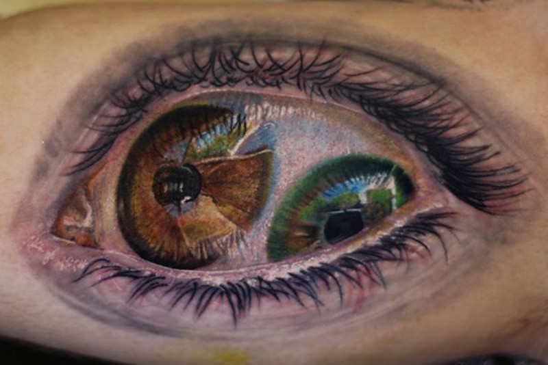 Creepy horrifying designed double eye colored tattoo on arm