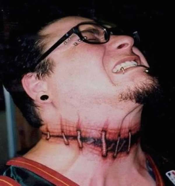 Creepy horror movie like colored neck tattoo of bloody stitches