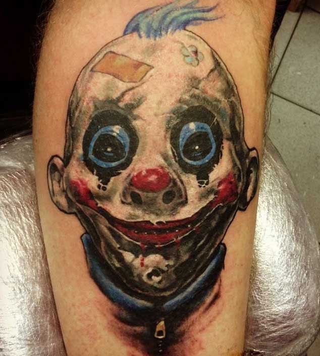 Creepy horror movie like colored smiling clown tattoo