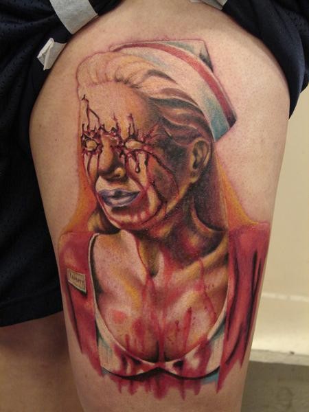 Creepy horror movie themed thigh tattoo of bloody monster nurse