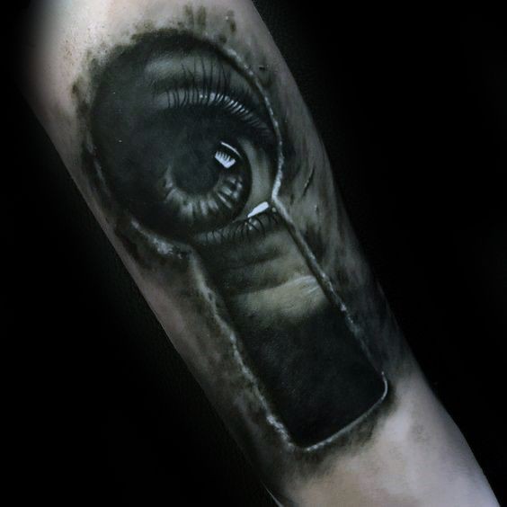 Creepy looking black and white tattoo of eye looking through keyhole