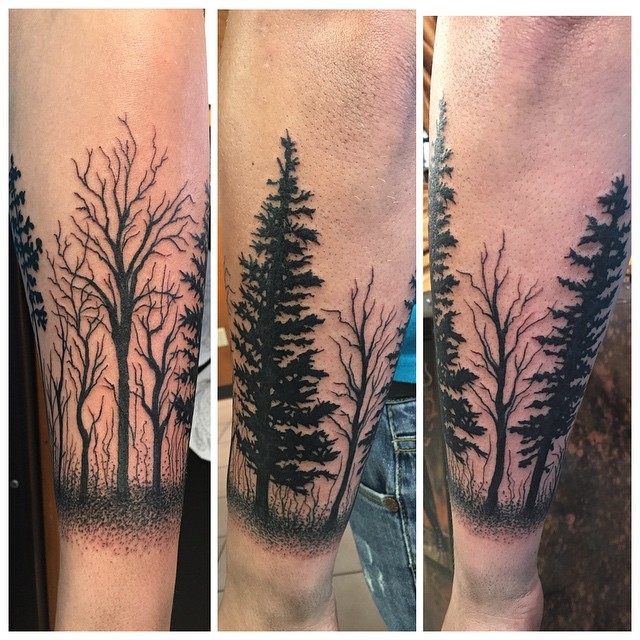 Creepy looking black ink dark deadly forest tattoo on forearm zone