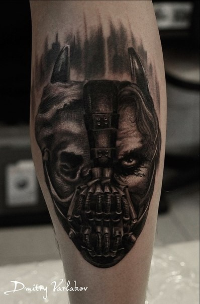 Creepy looking black ink leg tattoo of half Bane half Batman