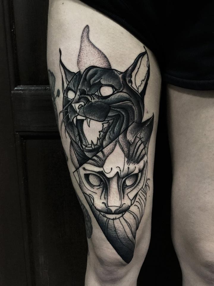 Creepy looking blackwork style thigh tattoo of black and white cats by Michele Zingales