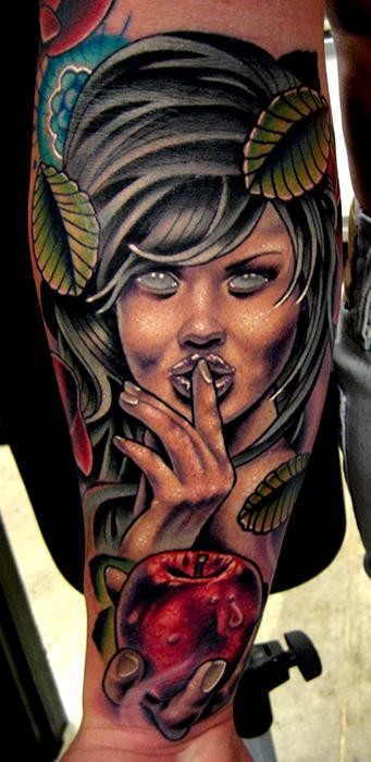 Creepy looking colored arm tattoo of seductive woman with leaves