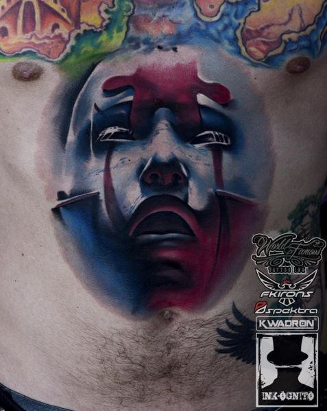 Creepy looking colored chest tattoo of mystical face