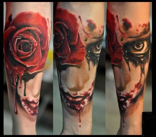 Creepy looking colored forearm tattoo of bloody face with rose