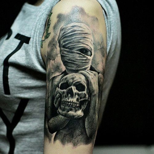 Creepy looking colored horror shoulder tattoo of mystical woman with skull