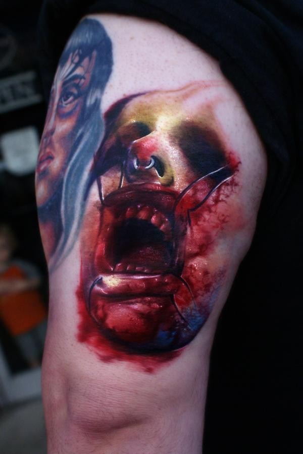 Creepy looking colored horror style tattoo of monster face