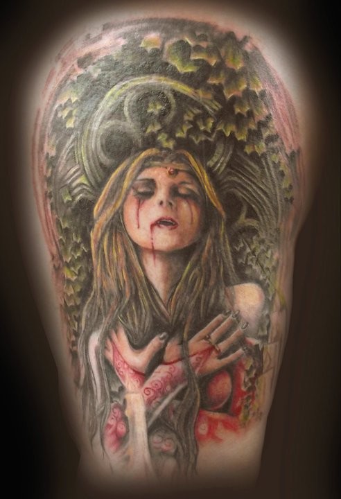 Creepy looking colored shoulder tattoo of bloody vampire woman with plants