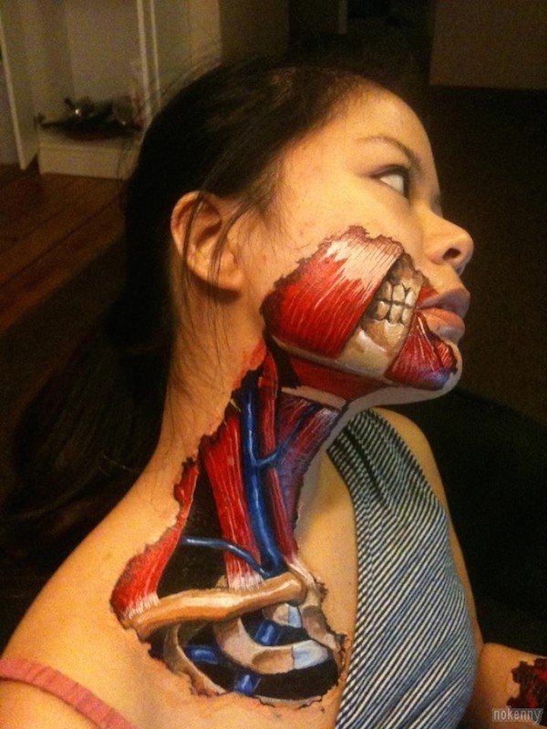 Creepy looking colored very detailed neck and face tattoo of human muscles and bones