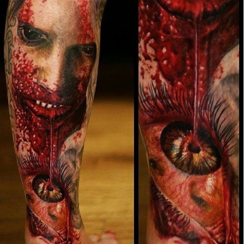 Creepy very detailed bloody zombie monster tattoo on leg