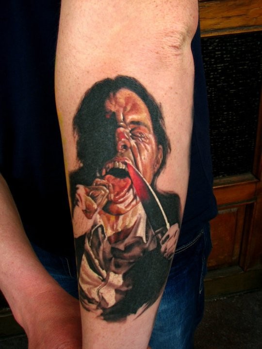 Creepy very realistic looking colored man with knife tattoo on forearm