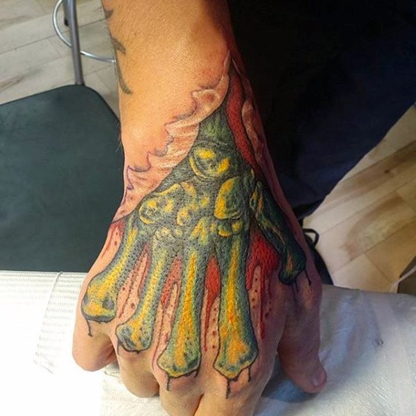 Creepy zombie green hand bones in torn ripped bloody skin colored tattoo