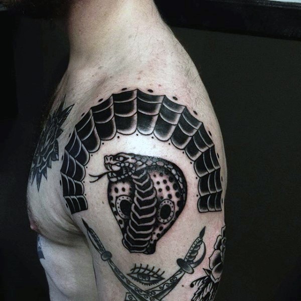 Crossed pirate daggers, cobra&quots head and spiderweb fragment tattoo on shoulder in old school style