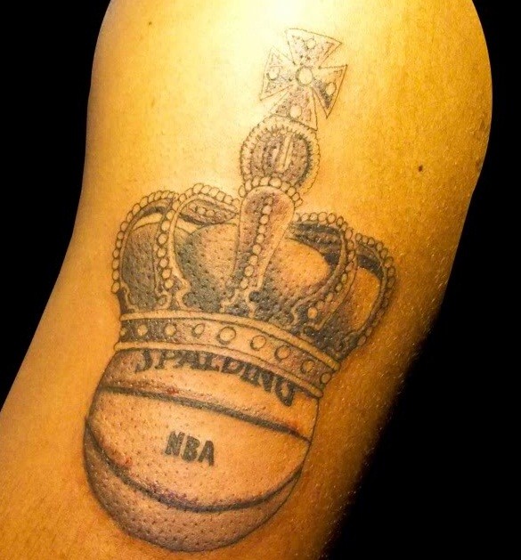 Crown and basketball on arm tattoo
