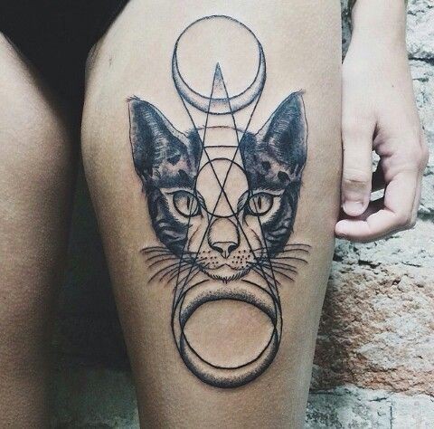 Cult like designed dot style thigh tattoo of cat head with various ornaments