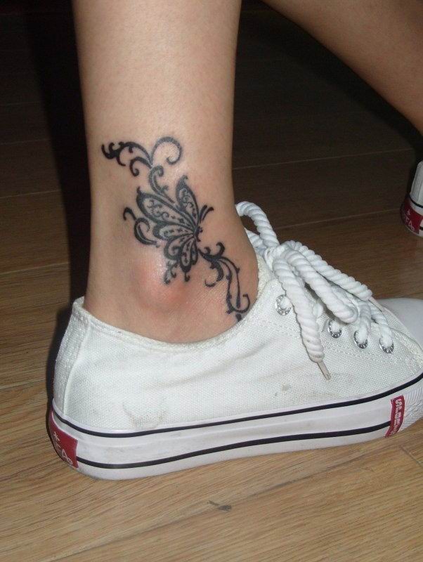 Curl simple butterfly tattoo on foot