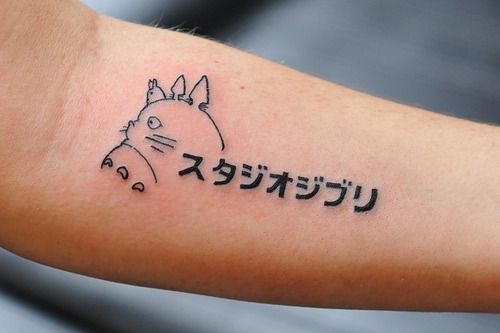 Cute Asian style cartoon hero slim tattoo on forearm with lettering