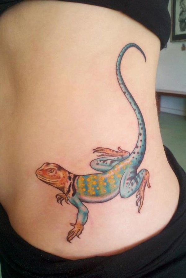 Cute big size bright colored lizard with long tail woman&quots side tattoo