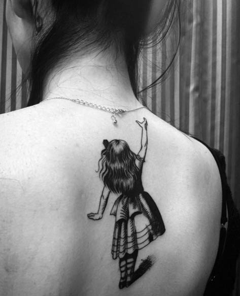 Cute black and white fairy tale girl tattoo on lady&quots upper back