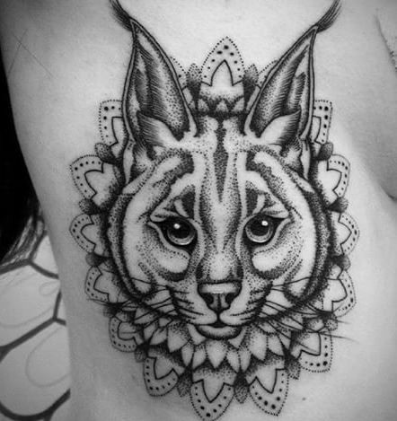 Cute black ink dot style side tattoo of caracal with floral ornament