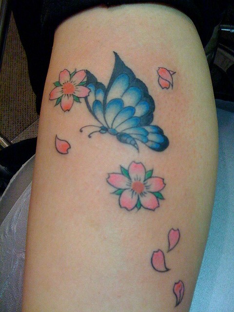 Cute butterfly tattoo with flowers on arm